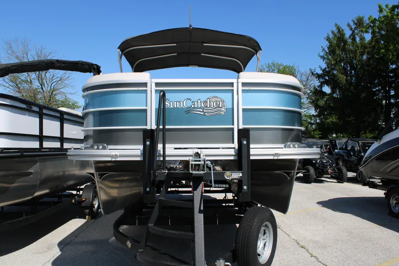 Slide: The Image of 2024 SunCatcher Select 22RC pontoon boat displayed outdoors on a sunny day. - 2