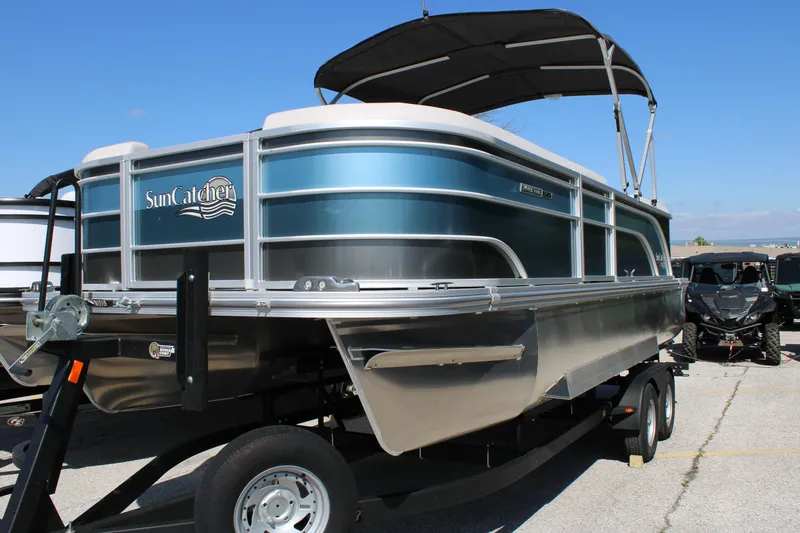 Slide: The Image of 2024 SunCatcher Select 22RC pontoon boat on trailer, featuring sleek design and canopy. - 3