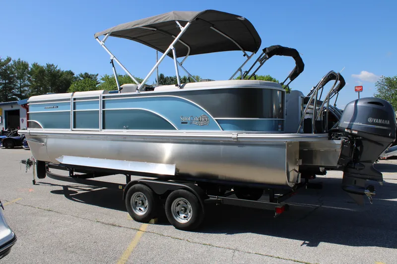 Slide: The Image of 2024 SunCatcher Select 22RC pontoon boat with Yamaha motor on trailer, parked outdoors. - 4