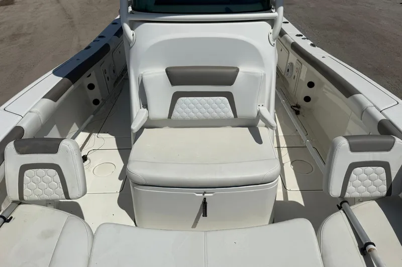 Slide: The Image of Interior seating of 2020 World Cat 325 CC boat, featuring white and gray upholstery. - 12