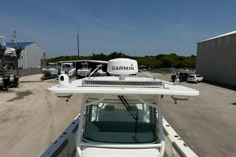 Slide: The Image of 2020 World Cat 325 CC boat with Garmin radar in a marina setting. - 13