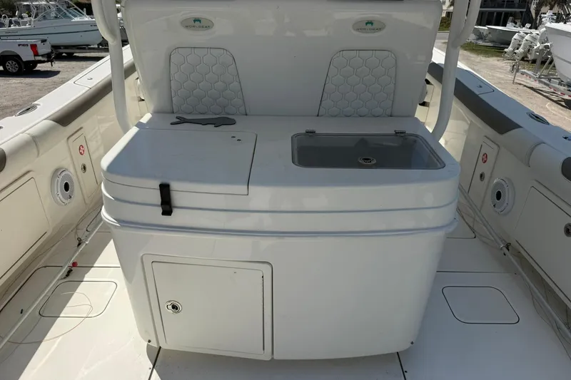 Slide: The Image of 2020 World Cat 325 CC boat interior with storage and seating area. - 15