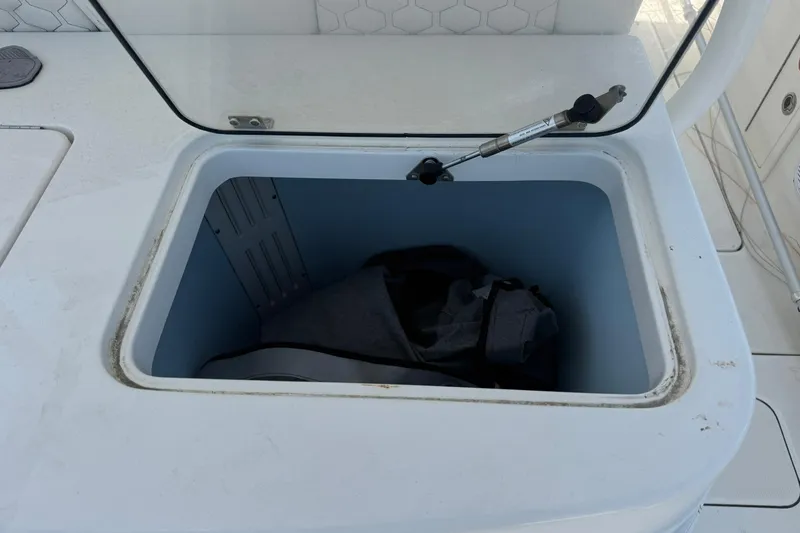 Slide: The Image of Open storage compartment on 2020 World Cat 325 CC boat. - 17