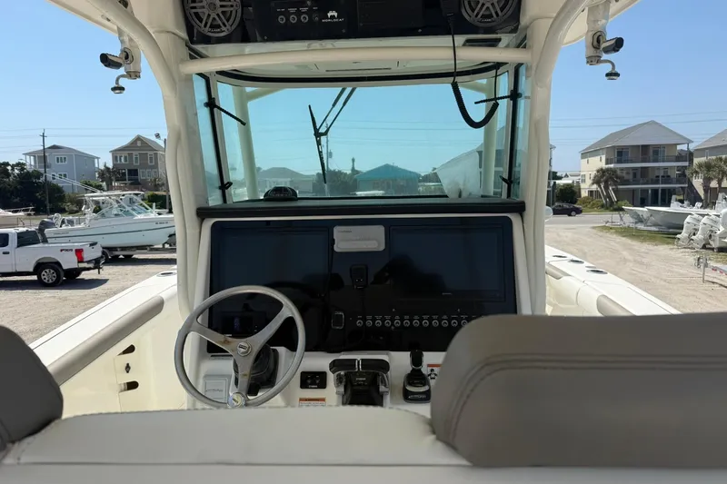 Slide: The Image of Cockpit view of 2020 World Cat 325 CC boat with modern controls and steering wheel. - 18
