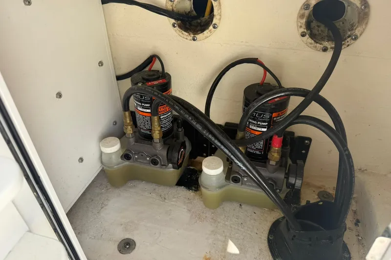 Slide: The Image of 2020 World Cat 325 CC steering pump system with hydraulic lines and fluid reservoirs. - 22