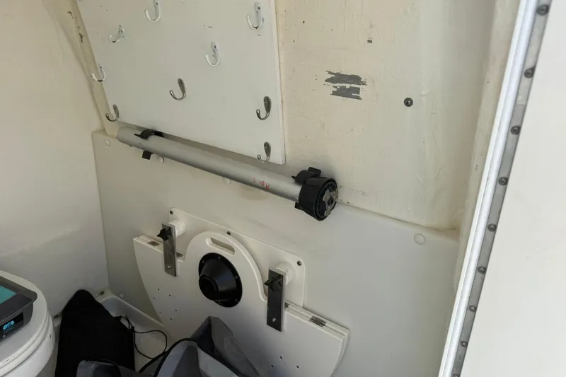Slide: The Image of Interior of a 2020 World Cat 325 CC boat, featuring storage hooks and equipment. - 23