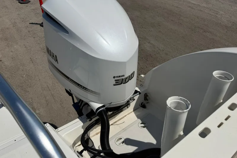 Slide: The Image of Yamaha 300 outboard motor on 2020 World Cat 325 CC boat, docked on sandy ground. - 29