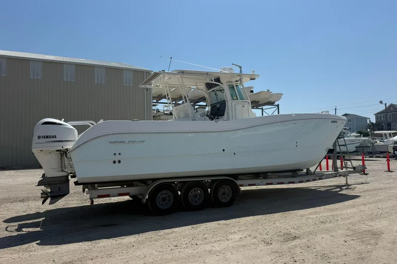 Slide: The Image of 2020 World Cat 325 CC boat on trailer with Yamaha engines, parked outdoors. - 3