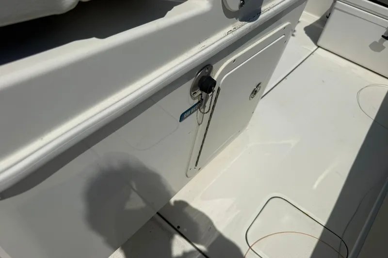 Slide: The Image of 2020 World Cat 325 CC boat deck with storage compartment and key. - 32