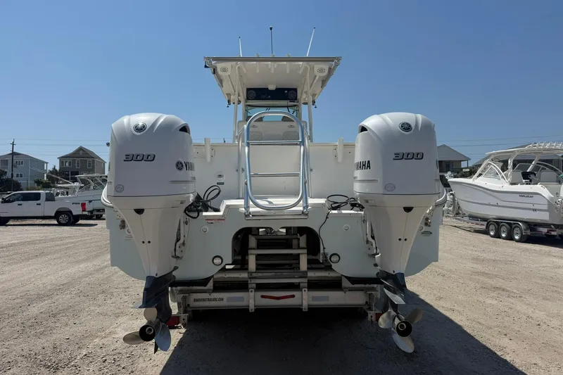 Slide: The Image of 2020 World Cat 325 CC boat with dual Yamaha 300 engines, parked on a sunny day. - 5