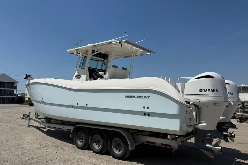 Slide: The Image of 2020 World Cat 325 CC boat on trailer with Yamaha engines, parked outdoors. - 6