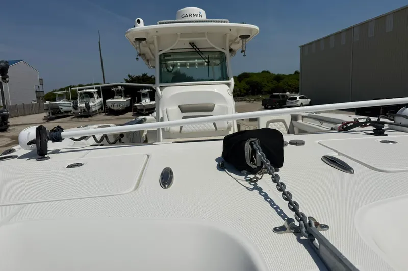 Slide: The Image of 2020 World Cat 325 CC boat with anchor chain, docked in marina. - 9