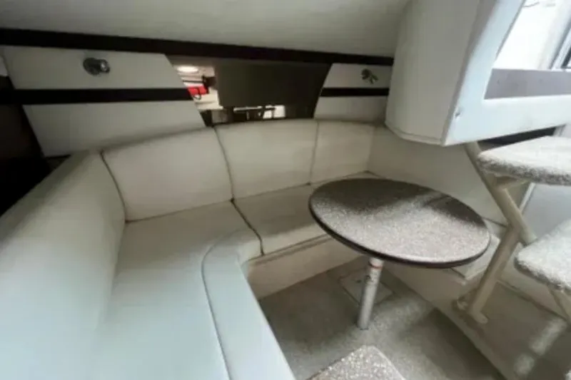 Slide: The Image of Interior of 2012 Cruisers Yachts 350 Express with white seating and round table. - 11