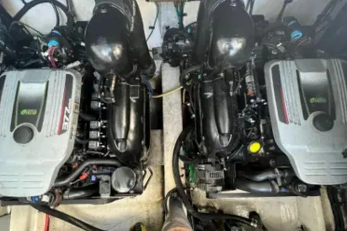 Slide: The Image of Twin engines of a 2012 Cruisers Yachts 350 Express, showcasing powerful marine engineering. - 12