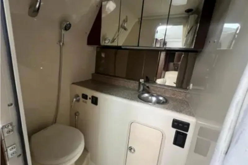 Slide: The Image of 2012 Cruisers Yachts 350 Express bathroom with shower, sink, and mirrored cabinet. - 14