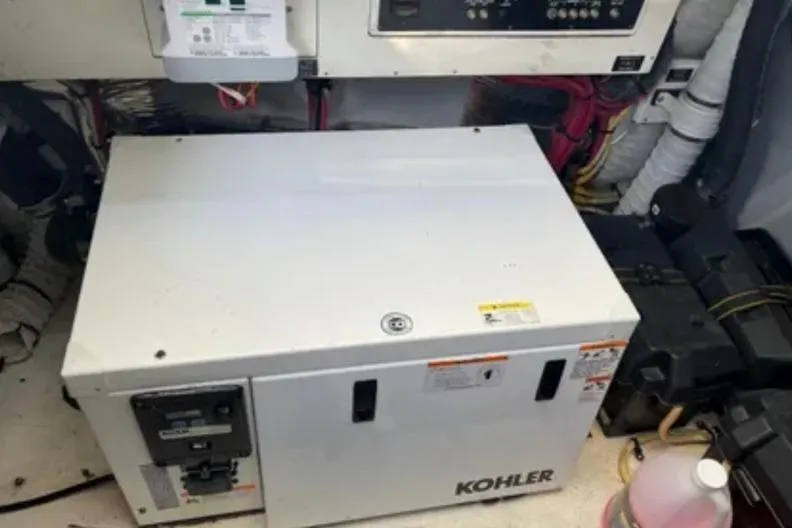 Slide: The Image of Kohler generator in 2012 Cruisers Yachts 350 Express engine room, surrounded by wiring and control panels. - 15