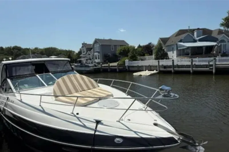 Slide: The Image of 2012 Cruisers Yachts 350 Express docked near waterfront homes. - 3