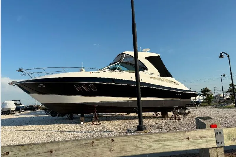 Slide: The Image of 2012 Cruisers Yachts 350 Express on dry dock under clear blue sky. - 4