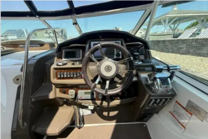 Slide: The Image of Cockpit of 2012 Cruisers Yachts 350 Express with steering wheel and control panel. - 6