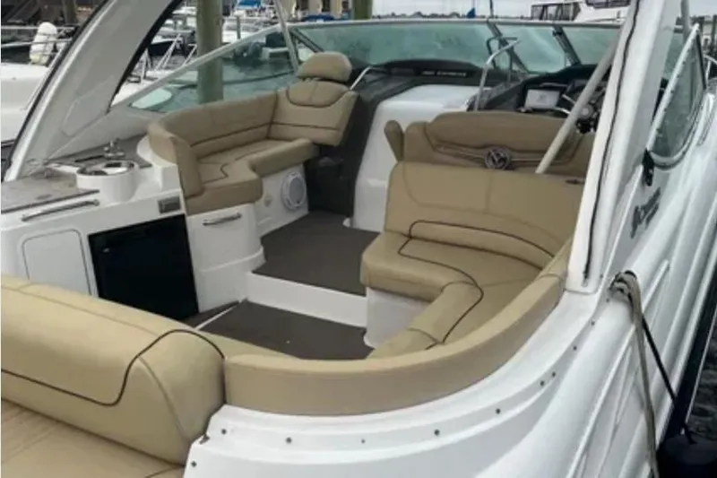 Slide: The Image of 2012 Cruisers Yachts 350 Express interior with beige seating and helm. - 7