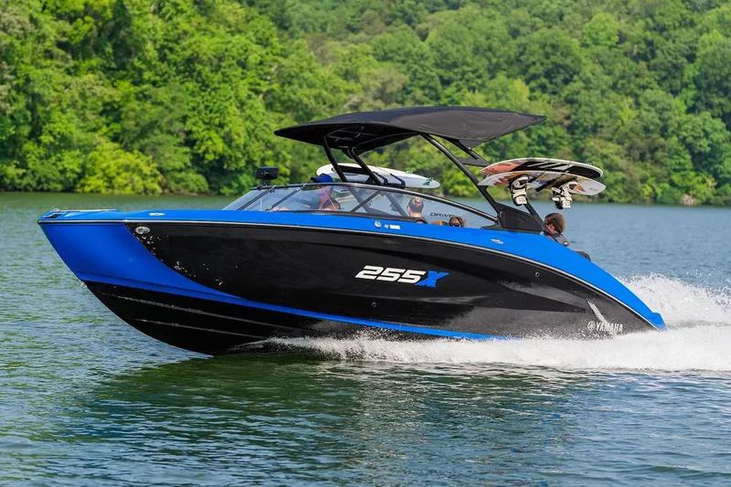 The Image of Manufacturer Provided Image: 2026 Yamaha Boats 255XD cruising on a lake with lush green background. - 1