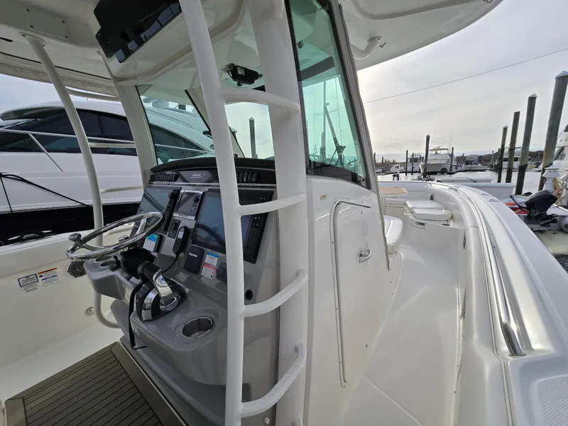 Slide: The Image of 2015 Boston Whaler 350 Outrage helm with modern controls and navigation equipment. - 15