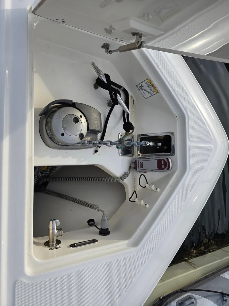 Slide: The Image of 2015 Boston Whaler 350 Outrage anchor compartment with winch and controls. - 25