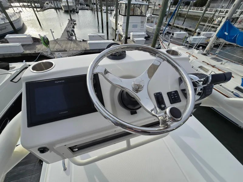 Slide: The Image of 2015 Boston Whaler 350 Outrage helm with steering wheel and navigation display. - 26