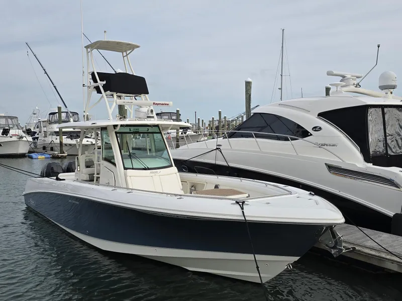 Slide: The Image of 2015 Boston Whaler 350 Outrage boat docked at marina, side view. - 3