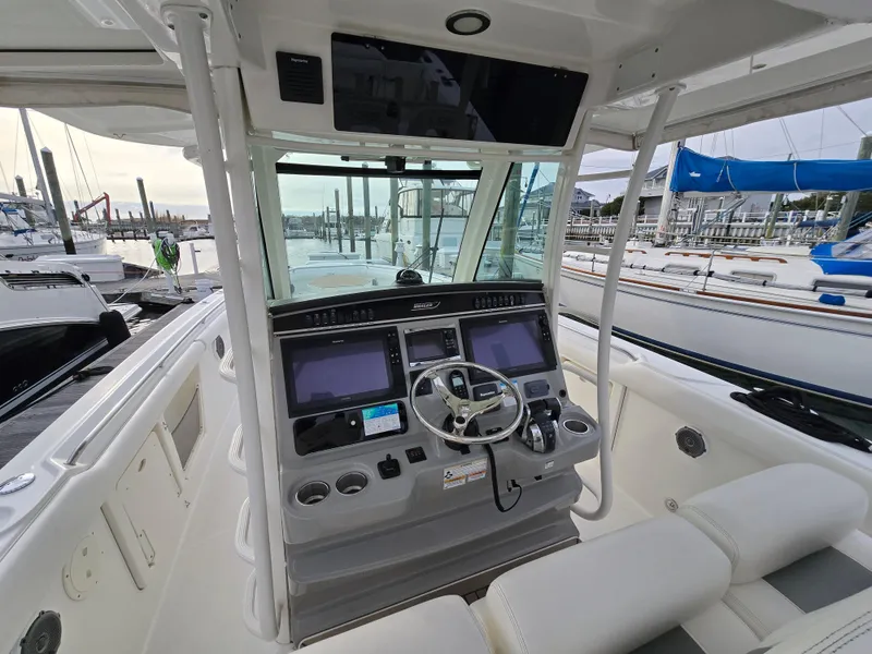 Slide: The Image of 2015 Boston Whaler 350 Outrage helm with dual screens at marina. - 7