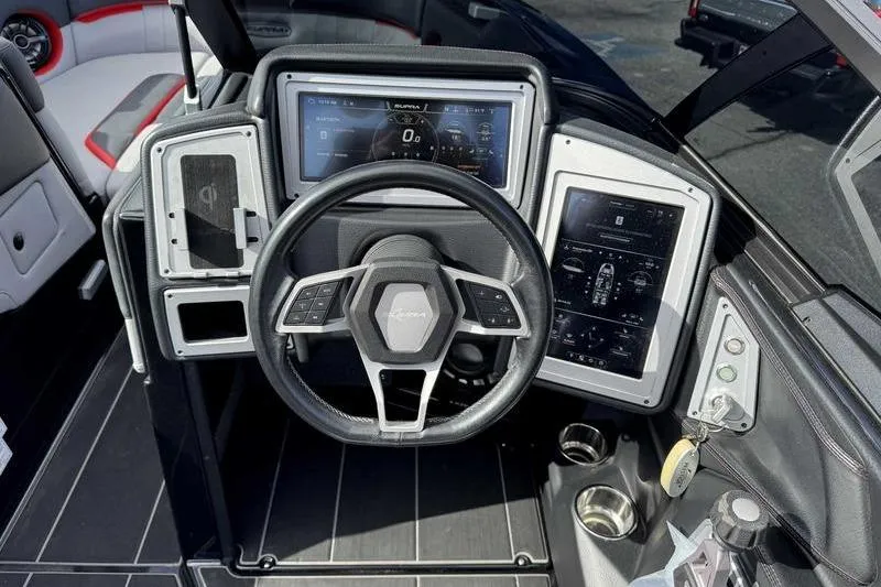 Slide: The Image of 2022 Supra SE boat dashboard with steering wheel and digital displays. - 14