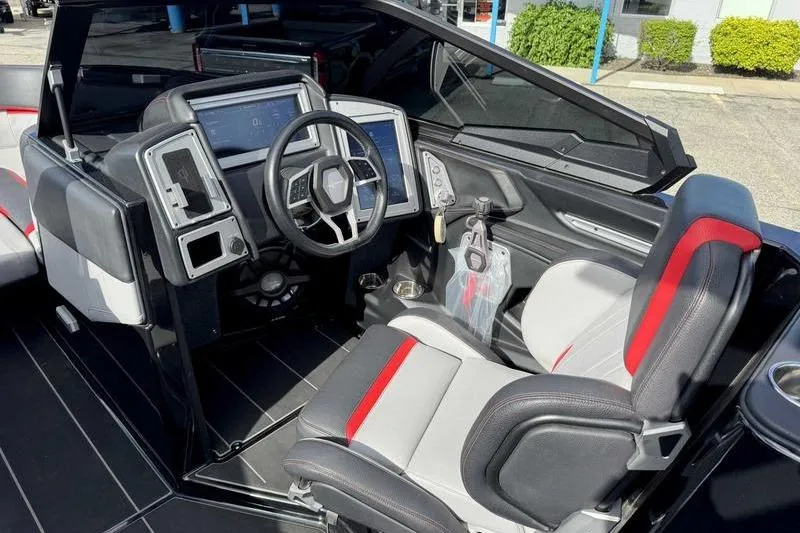 Slide: The Image of 2022 Supra SE boat interior with modern dashboard and sleek seating design. - 16