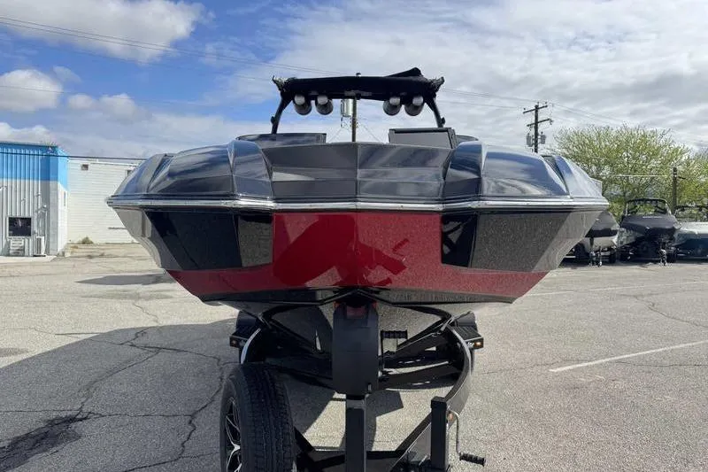 Slide: The Image of 2022 Supra SE boat on trailer, featuring sleek black and red design. - 3