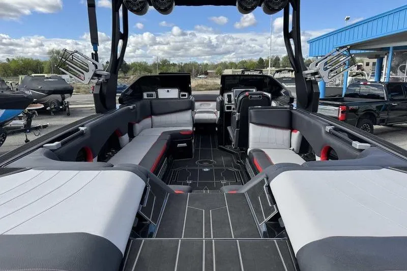 Slide: The Image of 2022 Supra SE boat interior with spacious seating and modern design under a cloudy sky. - 6
