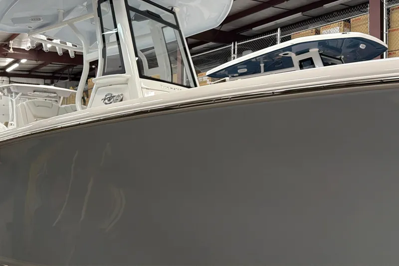 Slide: The Image of 2026 Tidewater 232 LXF boat in showroom, showcasing sleek design and modern features. - 5