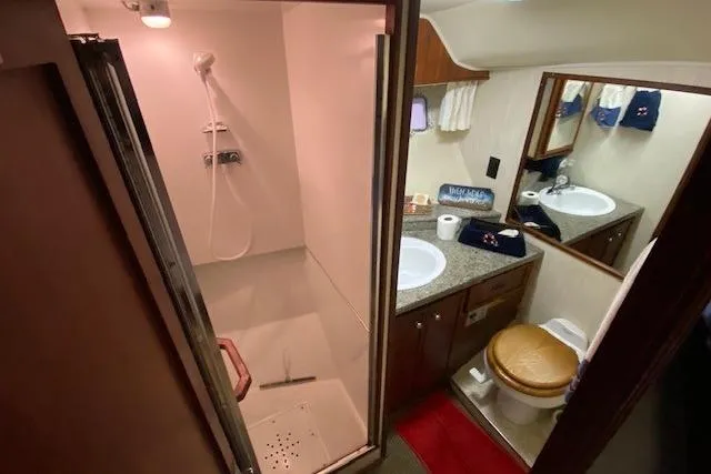Slide: The Image of 1977 Uniflite 42 Convertible yacht bathroom with shower, sink, and toilet. - 15
