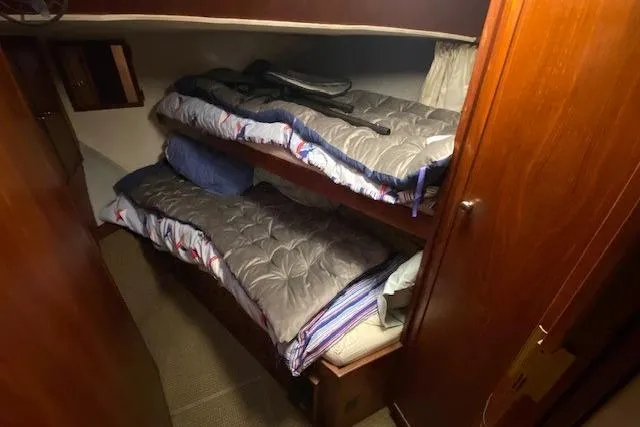 Slide: The Image of 1977 Uniflite 42 Convertible cabin with cozy bunk beds and wooden interior. - 16