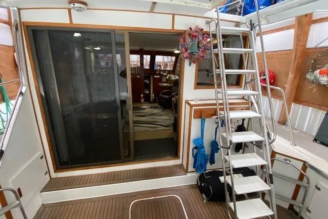 Slide: The Image of 1977 Uniflite 42 Convertible yacht interior with sliding glass door and ladder. - 4