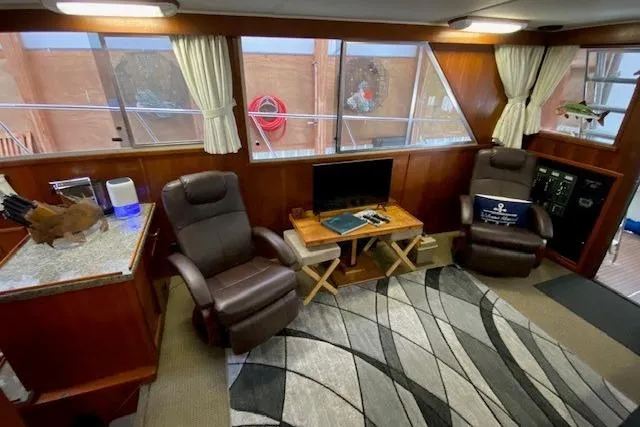 Slide: The Image of Interior of 1977 Uniflite 42 Convertible yacht with cozy seating and modern decor. - 8