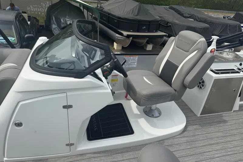 Slide: The Image of Captain's seat and helm of a 2020 Sylvan S3 CRS boat, featuring modern design. - 4