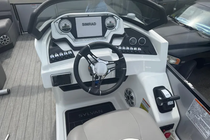 Slide: The Image of 2020 Sylvan S3 CRS boat dashboard with steering wheel and Simrad display. - 7