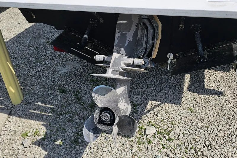 Slide: The Image of 2003 Caravelle 230 Walk Around Stern Drive propeller on gravel surface. - 10