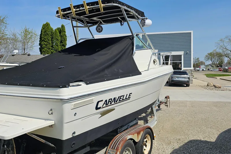 Slide: The Image of 2003 Caravelle 230 Walk Around Stern Drive boat on trailer, covered and parked outdoors. - 11