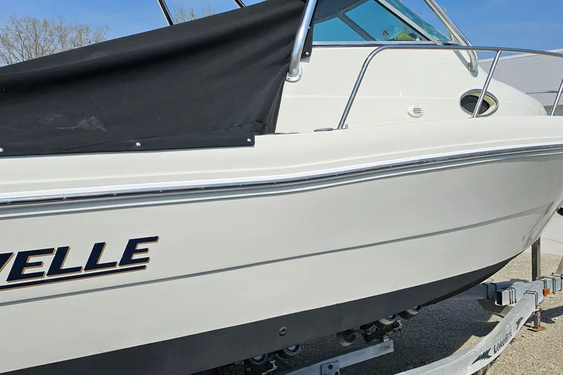 Slide: The Image of 2003 Caravelle 230 Walk Around Stern Drive boat on trailer, side view. - 12