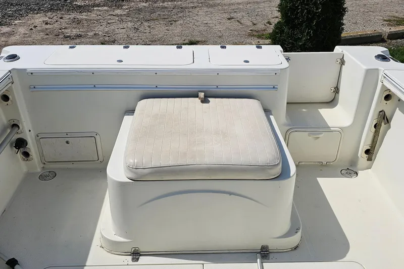 Slide: The Image of 2003 Caravelle 230 Walk Around Stern Drive boat interior with cushioned seating. - 14