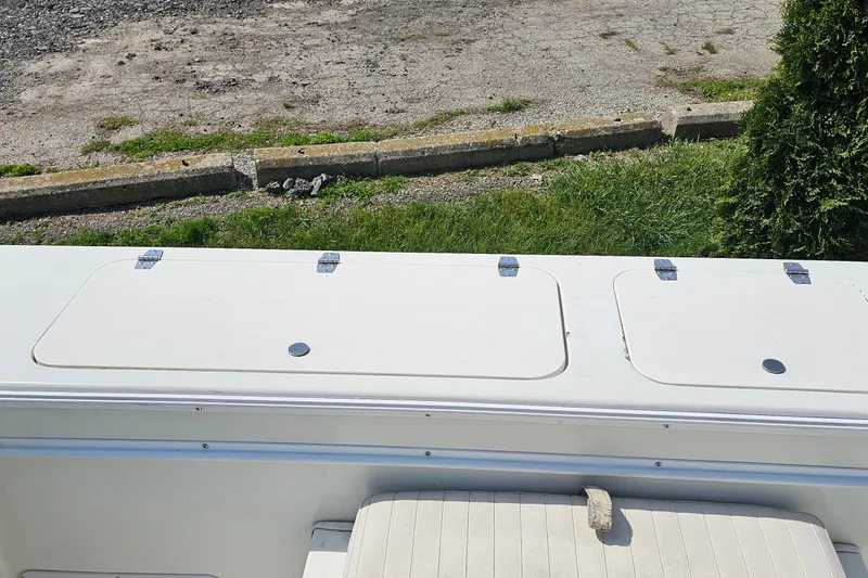 Slide: The Image of 2003 Caravelle 230 Walk Around Stern Drive boat deck with storage compartments. - 15