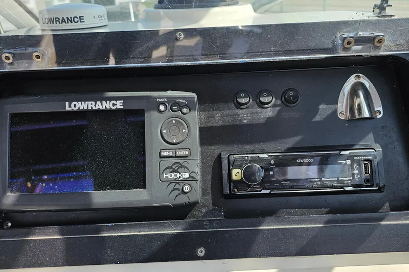 Slide: The Image of Dashboard of a 2003 Caravelle 230 Walk Around Stern Drive with Lowrance and Kenwood electronics. - 17