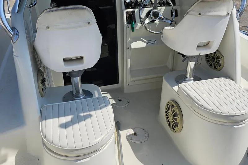 Slide: The Image of Interior of 2003 Caravelle 230 Walk Around Stern Drive boat with seating and steering wheel. - 20