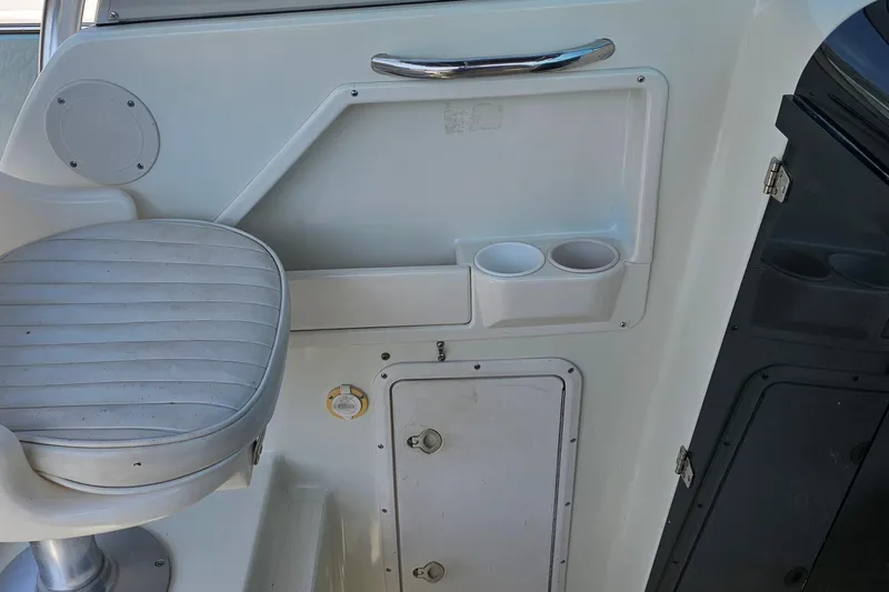 Slide: The Image of Interior of 2003 Caravelle 230 Walk Around Stern Drive with seat and cup holders. - 21