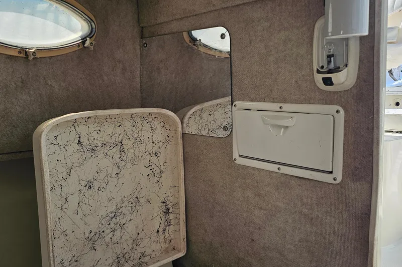 Slide: The Image of Interior of 2003 Caravelle 230 Walk Around Stern Drive boat cabin. - 24